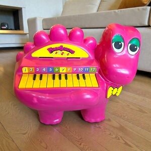 The Vintage 1977 Pink Dinosaur PIANOSAURUS Kids Piano by Proll Toys Inc. 14”x20”